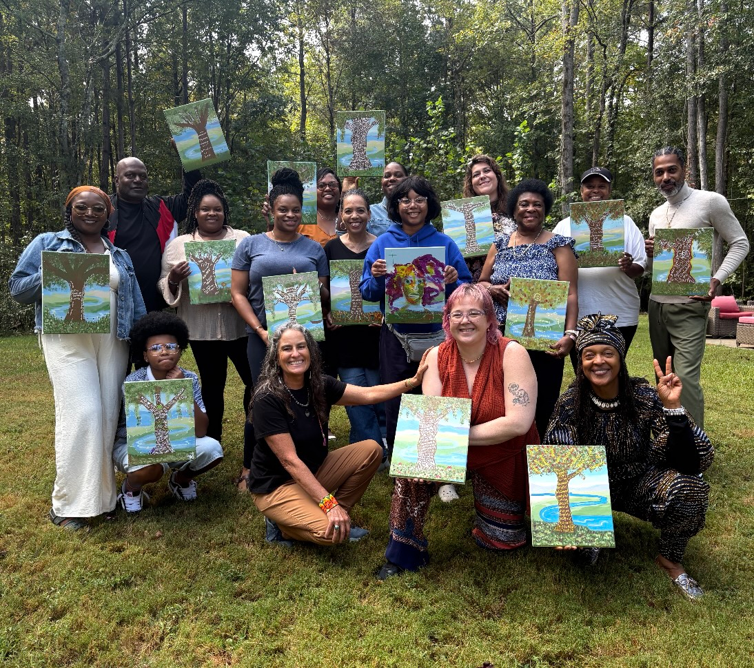 Paint and Shift community — everyone outside holding their paintings